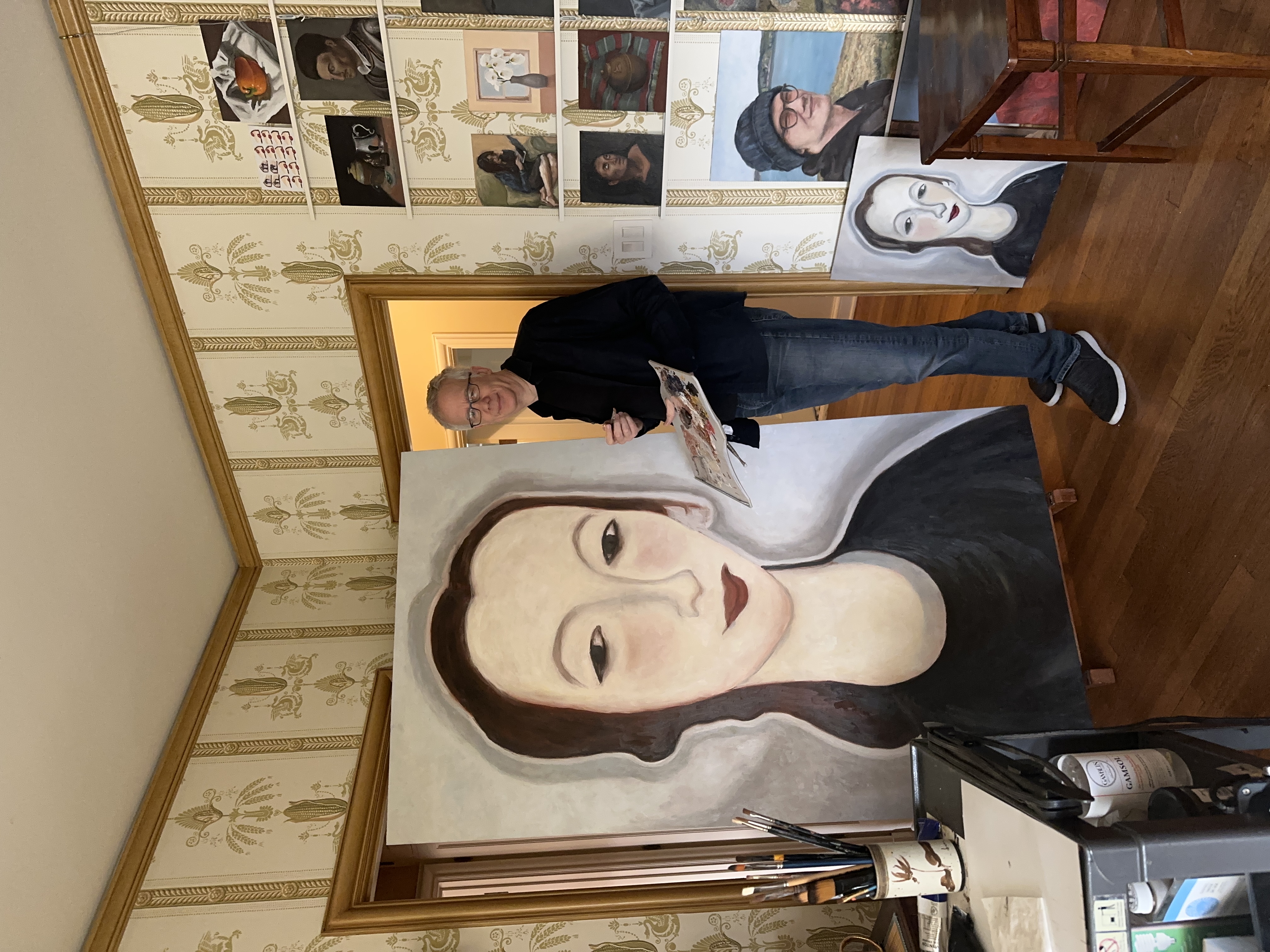 Andrew Conru with a large portrait painting