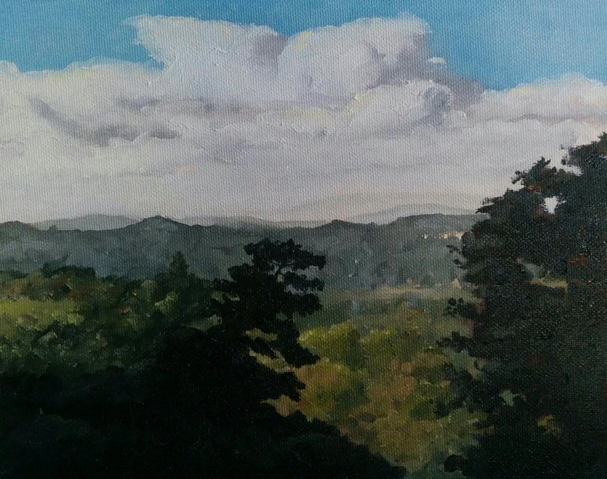 Bay area valley view: green hills under a big sky with clouds after a storm.